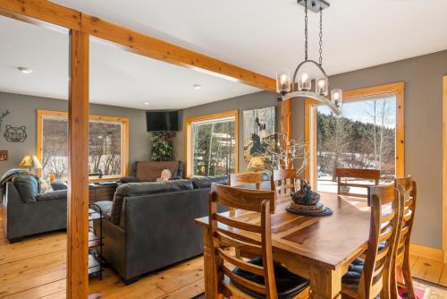 a dining room and living room with a table and a couch at WANDER INN, 4 Bedroom 2 Bath, 5 Min to Downtown, Custom Home in Leavenworth