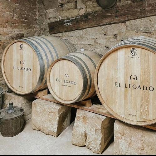 a group of wooden barrels in a brick wall at RIOJA VALLEY Apartamentos en el corazón de La Rioja in Cenicero
