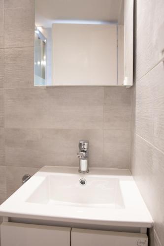 a bathroom with a white sink and a mirror at TRADITIONAL HOUSE ALEPIS IN AREOPOLIS in Areopolis