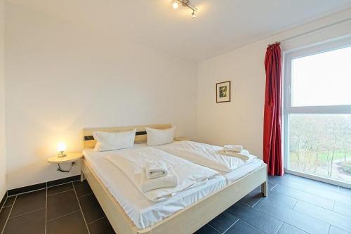 Voodi või voodid majutusasutuse NordseeResort Friesland NordseeResort Friesland 52-4-N toas