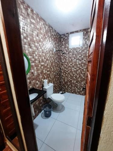 a small bathroom with a toilet in a room at casa praia de guajiru in Trairi