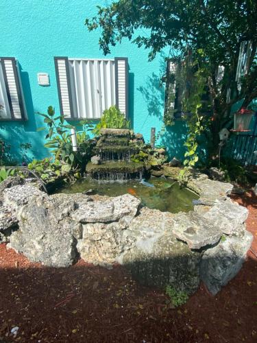 a small pond in front of a building at Hoosville Hostel (Formerly The Everglades Hostel) in Florida City