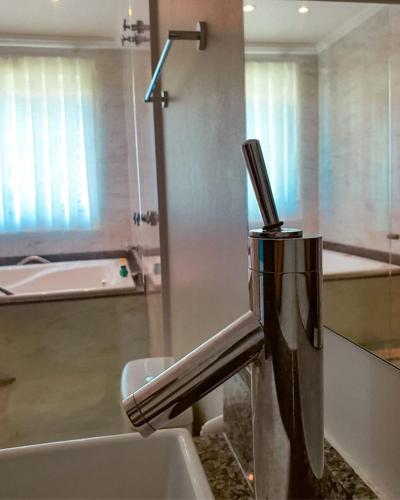 a bathroom sink with a faucet on a counter at Pousada Cantinho da Praia in Paraty