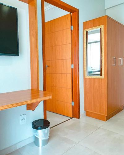a room with a wooden cabinet and a door at Pousada Cantinho da Praia in Paraty