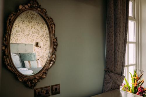 a mirror hanging on a wall in a room at The Queens Hotel in Lytham St Annes
