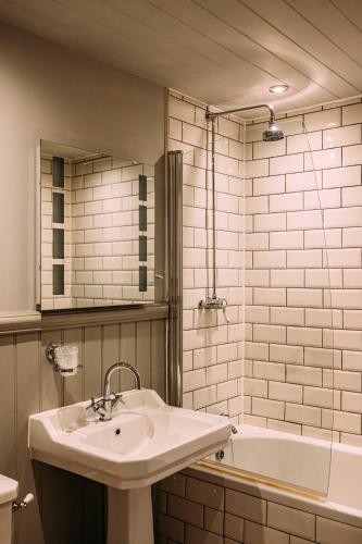 a bathroom with a sink and a bath tub at The Queens Hotel in Lytham St Annes