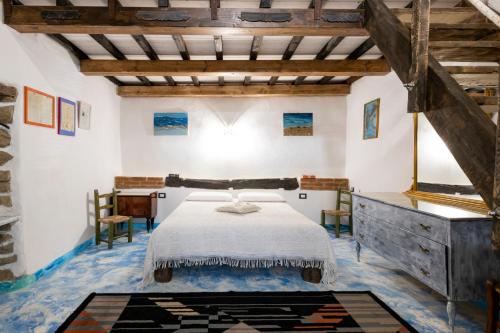 a bedroom with a bed and a table and chairs at La Pergola in Gergei