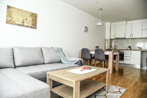 a living room with a couch and a table at Suncokret Apartmani Loznica in Loznica
