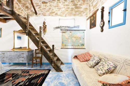 a living room with a couch and a staircase at La Pergola in Gergei