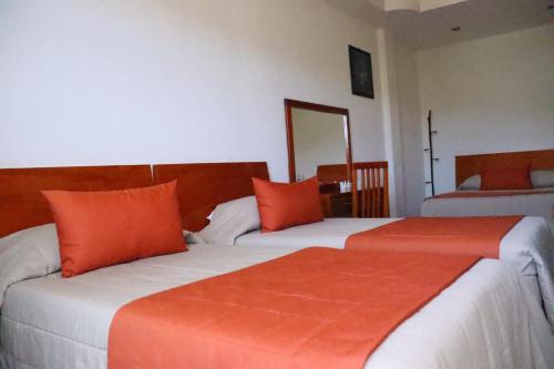 Ein Bett oder Betten in einem Zimmer der Unterkunft Hotel Señorial Tlaxcala