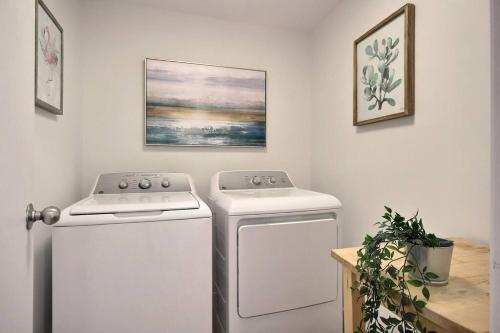 a kitchen with two white appliances in a room at North House - Spectacular 3 Bedroom Old Quebec Penthouse in Quebec City
