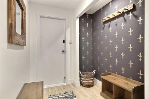 a hallway with a black wall with gold stars on it at North House - Spectacular 3 Bedroom Old Quebec Penthouse in Quebec City