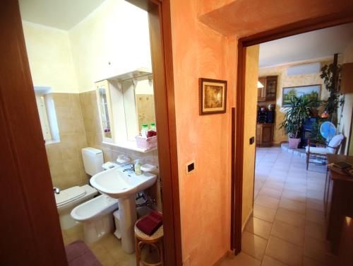 a bathroom with a sink and a toilet at Mella house garden relax in Lezzeno