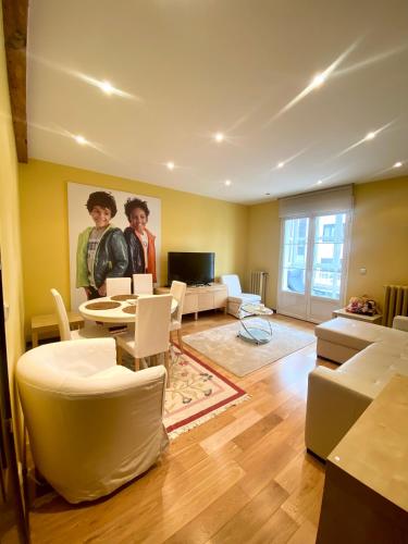 a living room with a couch and a table and chairs at Grand Plaza Mio Cid in Burgos