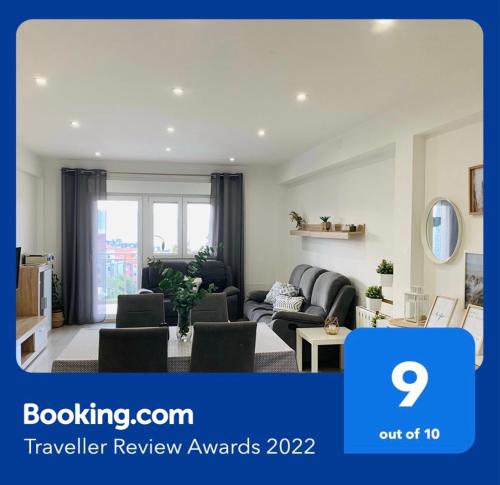 a living room with a couch and a table at Apartamento con piscina en el centro de Sanxenxo in Sanxenxo