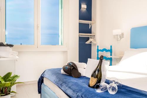 a blue and white bedroom with a bed with two guitars at Camera Adelaide in Deiva Marina