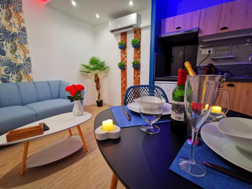 - un salon avec une table, des verres à vin et un canapé dans l'établissement Aux Bulles, à Limoges