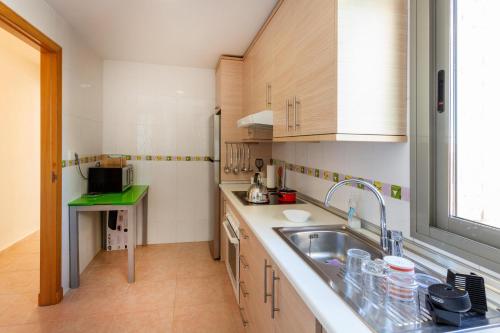 a kitchen with a sink and a counter top at Penthouse with spectacular views in Guardamar del Segura