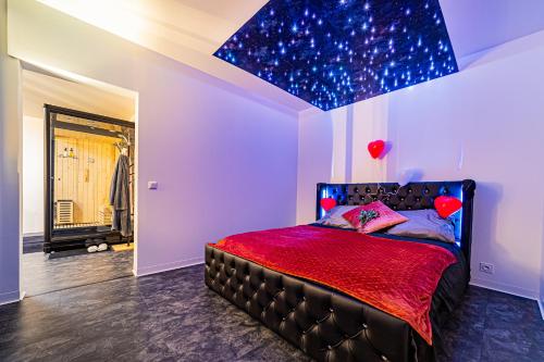 a bedroom with a bed with a starry ceiling at superbe appartement de charme moulin de Baverans . in Baverans