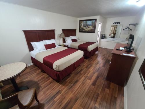 En eller flere senger på et rom på Homestead Motel