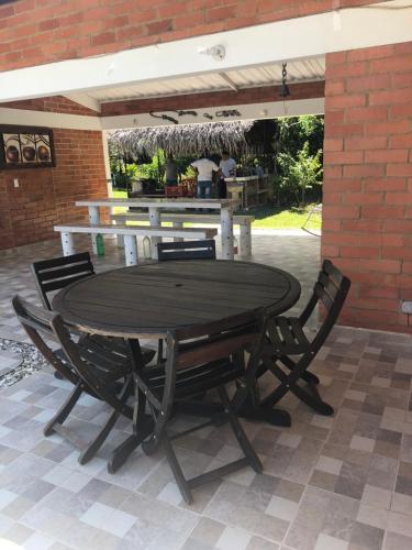 a wooden table and chairs on a patio at FINCA FILANDIA in San Joaquín