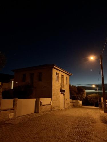 a small building with a street light next to it at Casa da Clarinha in Penalva do Castelo