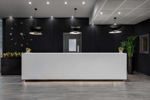 a large white table in a room with black walls at Radisson Blu Hotel London Stansted Airport in Stansted Mountfitchet