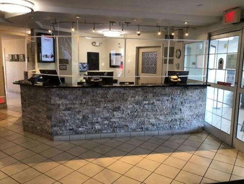 a bar in a restaurant with a stone wall at Sonesta Simply Suites Las Vegas Convention Center in Las Vegas