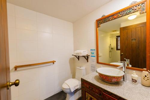 a bathroom with a sink and a toilet and a mirror at BTC Boutique Resort Private Pool Villas and Studios Hua Hin บ้านทะเลจีน บูติค รีสอร์ท หัวหิน in Hua Hin