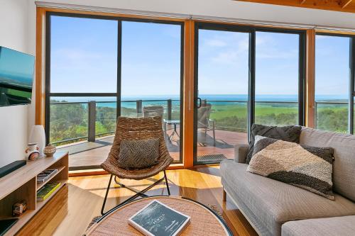a living room with a view of the ocean at Point of View Villas in Apollo Bay