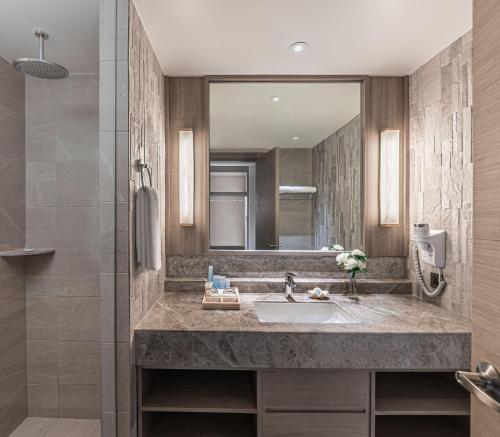 a bathroom with a sink and a mirror at Henann Park Resort in Boracay