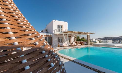 a villa with a swimming pool and a house at Luxury Ocean View Villa Mykonos Town Centre in Mýkonos City