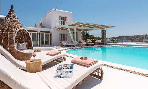 a villa with a swimming pool and a house at Luxury Ocean View Villa Mykonos Town Centre in Mýkonos City
