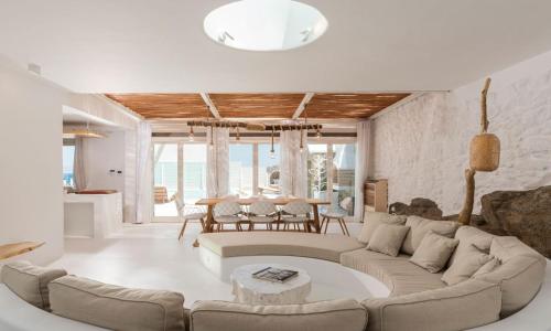 a living room with a large couch and a table at Luxury Ocean View Villa Mykonos Town Centre in Mýkonos City