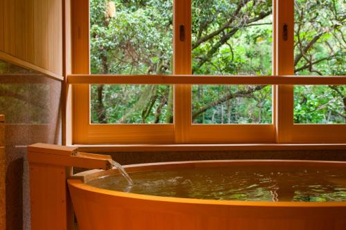 a bath tub in a room with a window at Ikyu in Ise