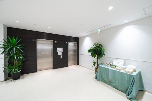a lobby with a table with a green table cloth at KOKO HOTEL Kagoshima Tenmonkan in Kagoshima