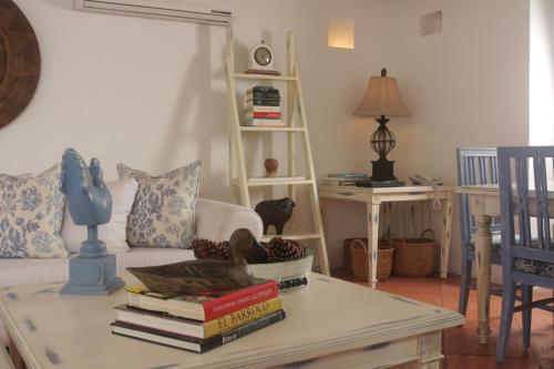 a living room with a table with books on it at Hotel Casa Quero in Cartagena de Indias