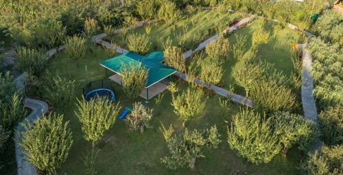 an overhead view of a building in a field with trees at The Orchard Retreat & Spa in Srinagar