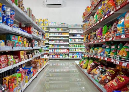 a grocery store aisle with many shelves of food at Apartemen MATARAM CITY YUDHISTIRA TOWER YOGYAKARTA in Kejayan