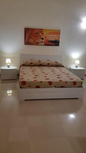 sypialnia z łóżkiem i zdjęciem lwa w obiekcie Savina's House 2 w mieście Veglie