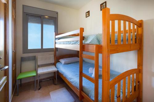 a bedroom with two bunk beds and a window at Penthouse with spectacular views in Guardamar del Segura