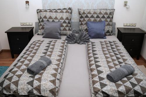 a bedroom with two beds with pillows on them at The Pearl of Zsofia in Esztergom