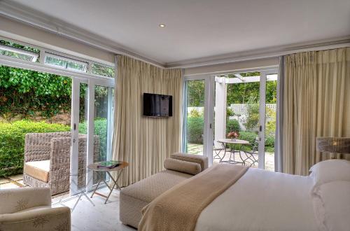 a bedroom with a large bed and a balcony at Sea Five Boutique Hotel in Cape Town