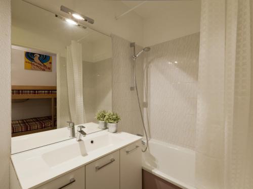 a white bathroom with a sink and a shower at Studio Brides-les-Bains, 1 pièce, 4 personnes - FR-1-512-54 in Brides-les-Bains