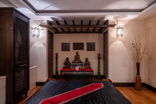 a bedroom with a bed with a red blanket at Fame Residence Kemer & Spa in Kemer