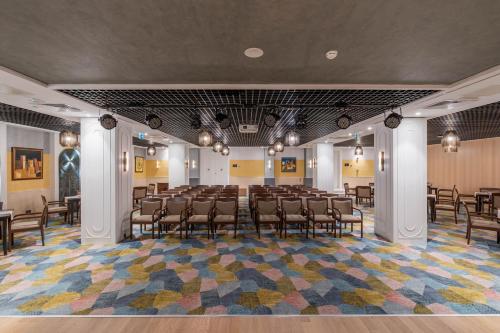 a large room with chairs and tables in it at Fame Residence Kemer & Spa in Kemer