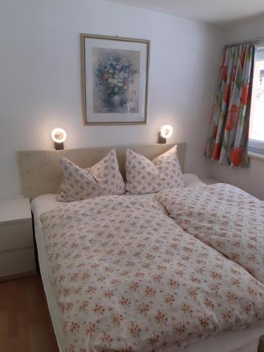 a bedroom with a bed with a flowered comforter at TOP Garden View in Volders