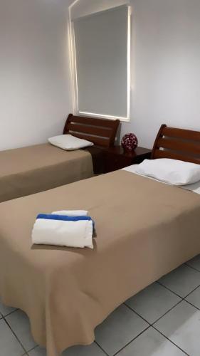 two beds sitting in a room with aermottermott at Villa Anna Maria in Coral Bay