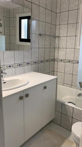 a bathroom with a sink and a toilet and a tub at Villa Anna Maria in Coral Bay