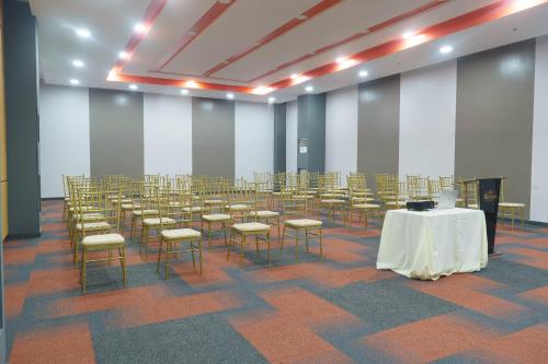 a room with rows of chairs and a table in it at Go Hotels Plus Tuguegarao in Tuguegarao City